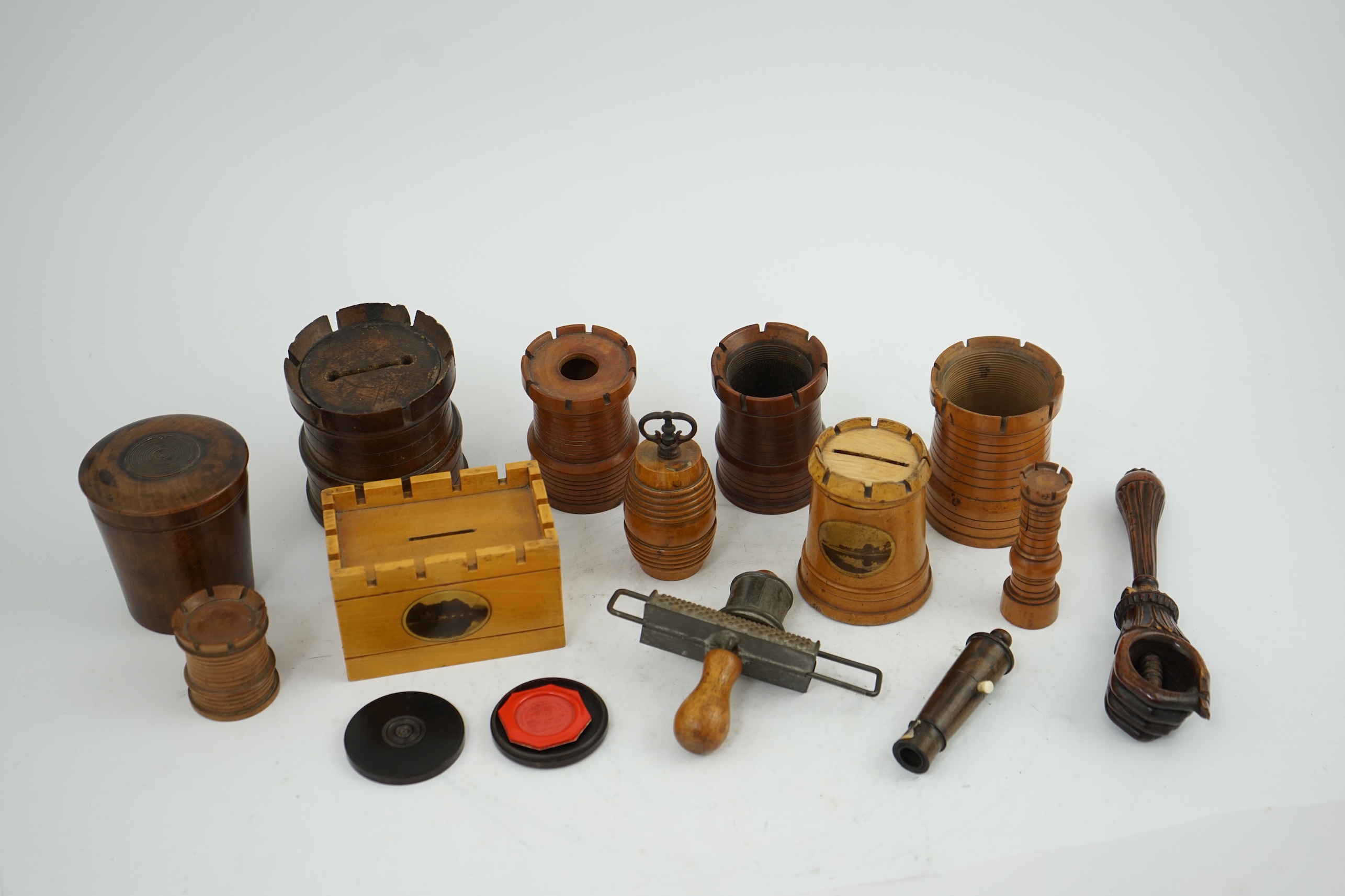 A collection of Victorian and Edwardian treen comprising castellated boxes, nutcrackers, kitchenalia and a glass holder. Condition - fair to good